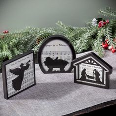 three paper cut nativity cards on top of a table