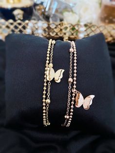 Our Beautiful Butterfly Beaded Two Double Chain Bracelet in Gold & Rose Gold Colour is the perfect blend of style and sophistication.  Made with high-quality materials, this chain exudes luxury and is sure to make a statement. - Stainless Steel - Non-Tarnish  - Nickel Free  - Water Resistant  The classic design is timeless and will never go out of style. It's the perfect accessory for any occasion, whether you're dressing up for a night out or just want to add a touch of glam to your everyday lo Trendy Beaded Chain Bracelets For Party, Party Rose Gold Bracelets With Delicate Chain, Rose Gold Delicate Chain Bracelet For Party, Elegant Metal Beaded Bracelets With Chain, Elegant Metal Charm Bracelet With Double Chain, Elegant Metal Charm Bracelet With Delicate Chain, Elegant Beaded Metal Charm Bracelet, Elegant Beaded Bracelets For Party, Trendy Rose Gold Bracelet With Delicate Chain