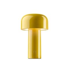 a yellow table lamp on a white background with the light turned off to show its dim lighting