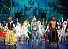 the cast of disney's beauty and the beast on stage in front of a castle