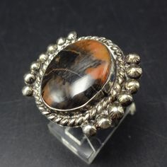 VINTAGE PETRIFIED WOOD RING DESCRIPTION:  With a breathtaking specimen of petrified wood set in sterling silver on a split shank band, this ring will be a treasured addition to your collection of fine vintage Native American jewelry. MEASUREMENTS:  Ring face measures 1" x 7/8" Cabochon measures 19mm x 15mm RING SIZE: 8 1/2 WEIGHT:  10.2 grams SIGNED: UITA15 STERLING:  unmarked, verified sterling silver Native American Vintage, Jewelry Measurements, Vintage Native American Jewelry, Wood Ring, Jewelry Picture, Wood Rings, Split Shank, Petrified Wood, American Jewelry