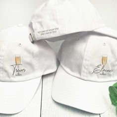 These custom champagne print baseball hats are perfect for a classy bachelorette, bridal shower, girls trip, birthday, or other bubbly, boozy celebration. Personalize each hat with a name or location in modern script lettering.  Optional - add 1-2 lines of custom text to the back of each hat.  𝗣𝗘𝗥𝗦𝗢𝗡𝗔𝗟𝗜𝗭𝗔𝗧𝗜𝗢𝗡 * Add  a name or location (printed in script - up to 12 characters maximum) 𝗢𝗣𝗧𝗜𝗢𝗡𝗔𝗟: Add 1-2 lines of short custom text to each hat 3.00 per hat)  (printed in ALL CA White Snapback Hat For Party, White Adjustable Hat For Bachelorette Party, Adjustable White Mini Hats For Bachelorette Party, Party Snapback Hat With Curved Brim, Customizable Adjustable Party Hats, White Snapback Party Hat, Customizable Party Trucker Hat, White Trucker Baseball Cap For Party, Customizable Trucker Hat For Parties