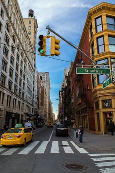 a traffic light hanging over a street next to tall buildings