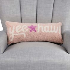 a gray chair with a pink pillow that says,'always you'on it