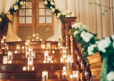 candles are lit on the steps leading to a wedding ceremony