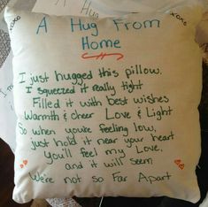 a pillow with writing on it that says a hug from home, i just hugged this pillow