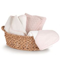 a wicker basket filled with pink and white blankets on top of a white background