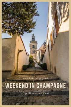 an alley way with steps leading up to a steeple and the words weekend in champagne