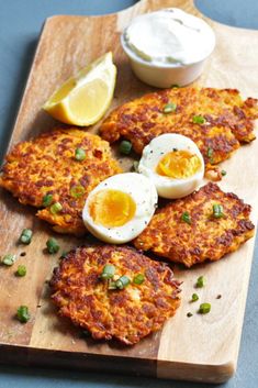 crab cakes with boiled eggs and chives on a cutting board