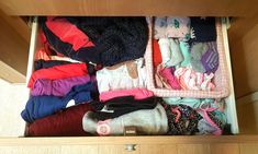 an open drawer filled with clothes and socks