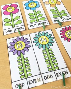 four flower cards with numbers on them sitting on a table