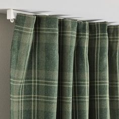 green plaid curtains hanging on the side of a wall