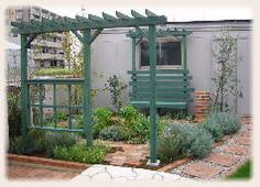 an outdoor garden with lots of green plants