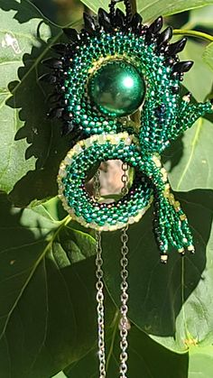 Hand beaded dragon using a mixture of Miyuki and Toho beads, woven around a 16mm crystal based green faux pearl focal bead. Beaded Dragon, Toho Beads, Stone Wrapping, Black Dragon, Beaded Necklaces, Focal Bead, Hand Beading, Yellow Black, Green Yellow