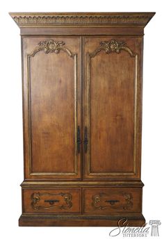 an old wooden armoire with ornate carvings on the top and bottom panel, against a white background