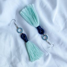 "Description: blue and silver boho tassel earrings, rhinestone dangle tassel earrings, sparkly boho blue earrings, teal macrame tassel earrings, boho navy and teal dangle earrings  For more dangle earrings, visit our shop! https://www.etsy.com/shop/cottondawnco Unique gift or self-indulgence, this pair of rhinestone dangle macramé earrings is the right balance of soft fiber and sparkly metal. Light teal cotton is 100% recycled. Silver color French earring hooks are nickel and lead-free but not hypoallergenic. Comes with clear rubber push backs. Length: approx. 4.4\" or 111.76 mm Round connector diameter: approx. 0.5\" or 12.7 mm (c) Cotton Dawn Co. PLEASE READ SHOP POLICIES BEFORE PURCHASE - Please read and accept our return policy before purchasing. Purchasing means that you agree with ou Boho Blue, Macrame Earrings, Metal Light, Light Teal, Recycled Silver, Earring Hooks, Blue Earrings, Shop Policies, Tassel Earrings