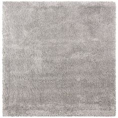 a gray rug that is on top of a white floor and has been placed in front of