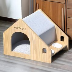 a dog house made out of wood and white carpet