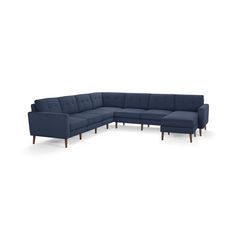 a blue sectional couch sitting on top of a white floor