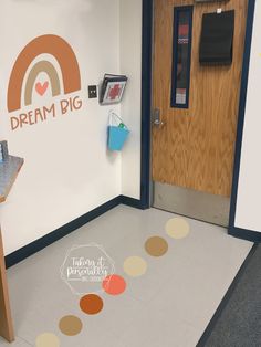 a room with a door, phone booth and sign on the wall that says dream big