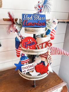 a patriotic hat stand with red, white and blue decorations on it that says god bless america