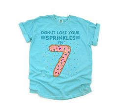 Donut lose your sprinkles but it's my 7th birthday! This cute donut illustration features a funny saying that's perfect for anyone who is celebrating their seventh birthday this year and loves donuts! This tee will be printed on Comfort Colors kids tees, which make for a trendy, comfortable, and unique tee to wear on their special day. A colorful rainbow sprinkle background with a tasty donut shaped like the number 7. You can change this design to feature different colored doughnut frosting. Cho Doughnut Frosting, Donut Outfit, Girls 7th Birthday, 7th Birthday Shirt, Donut Illustration, Seventh Birthday, Rainbow Sprinkle, Donut Shirt, Cute Donuts