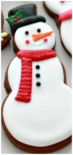 decorated cookies with frosting and icing are arranged in the shape of a snowman