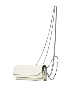 Smooth white calfskin Baguette bag with slight matte-shine and olive edging. 3 interior compartments with 2 card slots. Fold-over flap with magnetic closure. Leather lining in wine-color. Silver-tone logo stamp on front. One adjustable leather strap for shoulder carry. One detachable silver-tone rope-chain for cross-body One detachable silver-tone ball chain for shoulder carry. -------------- Also available in Black , camel, and Ice Blue. Bag size: approx. 9”W x 3.5”H x 2”D (23cm x 7cm x 5cm). A White Rectangular Wallet On Chain For Evening, Formal White Rectangular Wallet On Chain, Trendy Leather Baguette Bag With Silver-tone Hardware, Travel Leather Baguette Bag With Silver-tone Hardware, Modern White Leather Clutch, Silver Leather Bag With Chain Strap, Leather Baguette Bag With Silver-tone Hardware, Luxury White Leather Wallet On Chain, White Calf Leather Bag With Silver-tone Hardware