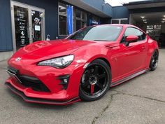 a red sports car parked in front of a building