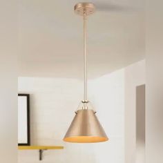 a light that is hanging from the ceiling in a room with white walls and flooring