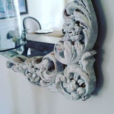 an ornate mirror hanging on the wall