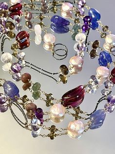 50 inches of gorgeousness, bold and unique  This necklace is made with a vast variety of stones, different shapes and colors all coordinated in one cohesive design to show off the playful and happy look for special occasion or everyday wear. The focal point of this necklace is huge chunks of glorious pink tourmaline and tanzanite stone, that range in size from 13mm to 22mm.   I used colorful and coordinated stoned to complement the main colors . Stones are smoky quartz, rainbow and chocolate moo Multifunctional Jewelry, Moss Aquamarine, Long Statement Necklace, Tanzanite Stone, Pearls Necklace, Ring Shapes, Wife Gift, Cluster Earrings, Oxidized Sterling Silver