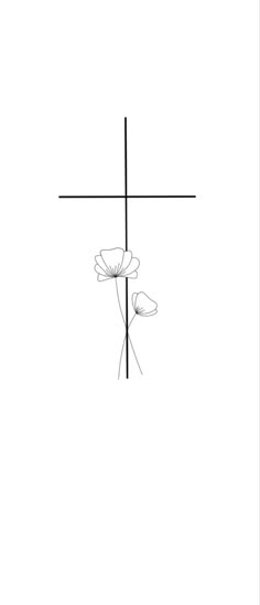 a black and white photo of a cross with flowers in the foreground on a plain background