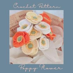 a bouquet of crocheted flowers sitting on top of white tissue paper with the words, craft pattern poppy flower