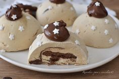 chocolate covered desserts on a white plate with one cut in half