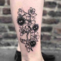 a black and white flower tattoo on the right leg, with an image of flowers in it