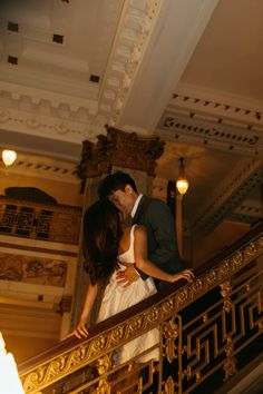 a bride and groom kissing on the stairs