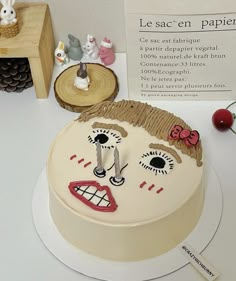 a cake decorated to look like a clown's face on a table with other decorations