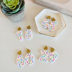 the numbers are decorated with confetti and sprinkles to make earrings