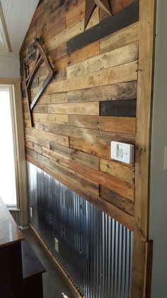 a wall made out of wooden planks with metal slats on the bottom and sides