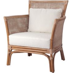 a wicker chair with white pillows on it's back and armrests