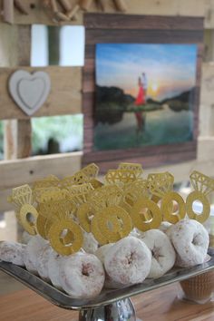 there are donuts that are on the tray and in front of some other items