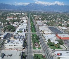 an aerial view of a city with mountains in the background