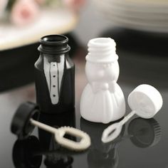 a black and white wedding cake topper next to a groom's tie