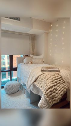 a bed with white blankets and pillows on top of it