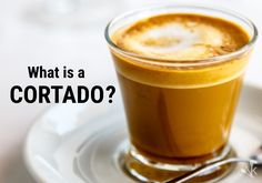 what is a cortado? with a cup of coffee and spoons on the side