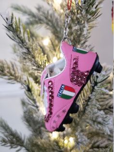 a pink shoe ornament hanging from a christmas tree