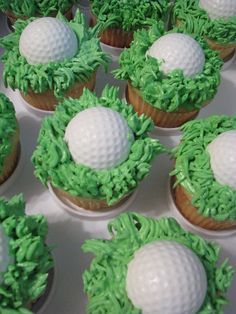 cupcakes with green frosting and golf balls on top are arranged in rows