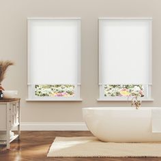 a bathtub sitting next to two windows with blinds on the window sill in front of it