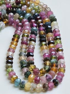 multicolored glass bead necklace on white background